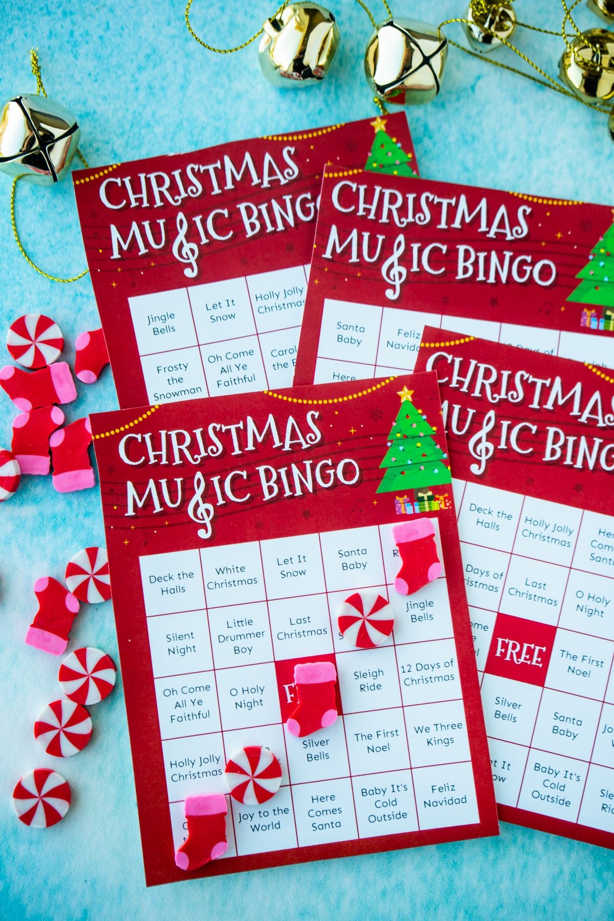 Cuatro cartones de bingo de música navideña sobre un fondo azul.