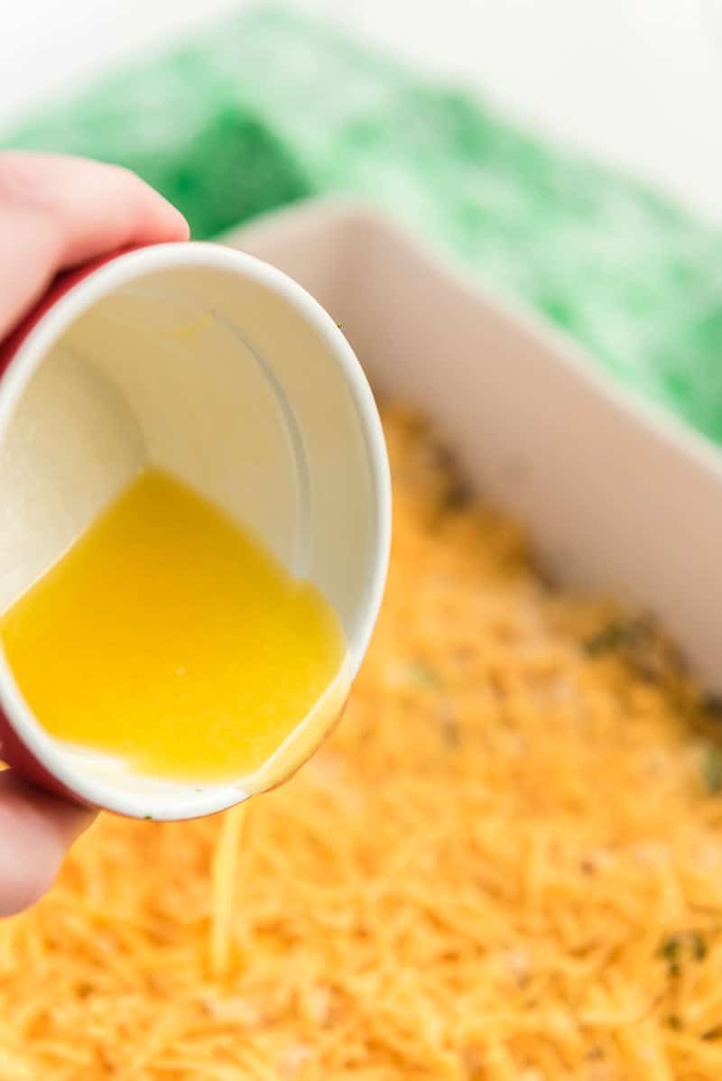Přidání másla do kuřecího kastrolu s ritzovými krekry