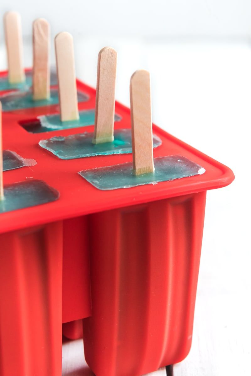 Punased popsicle-vormid, milles on sinist limonaadi popsicles